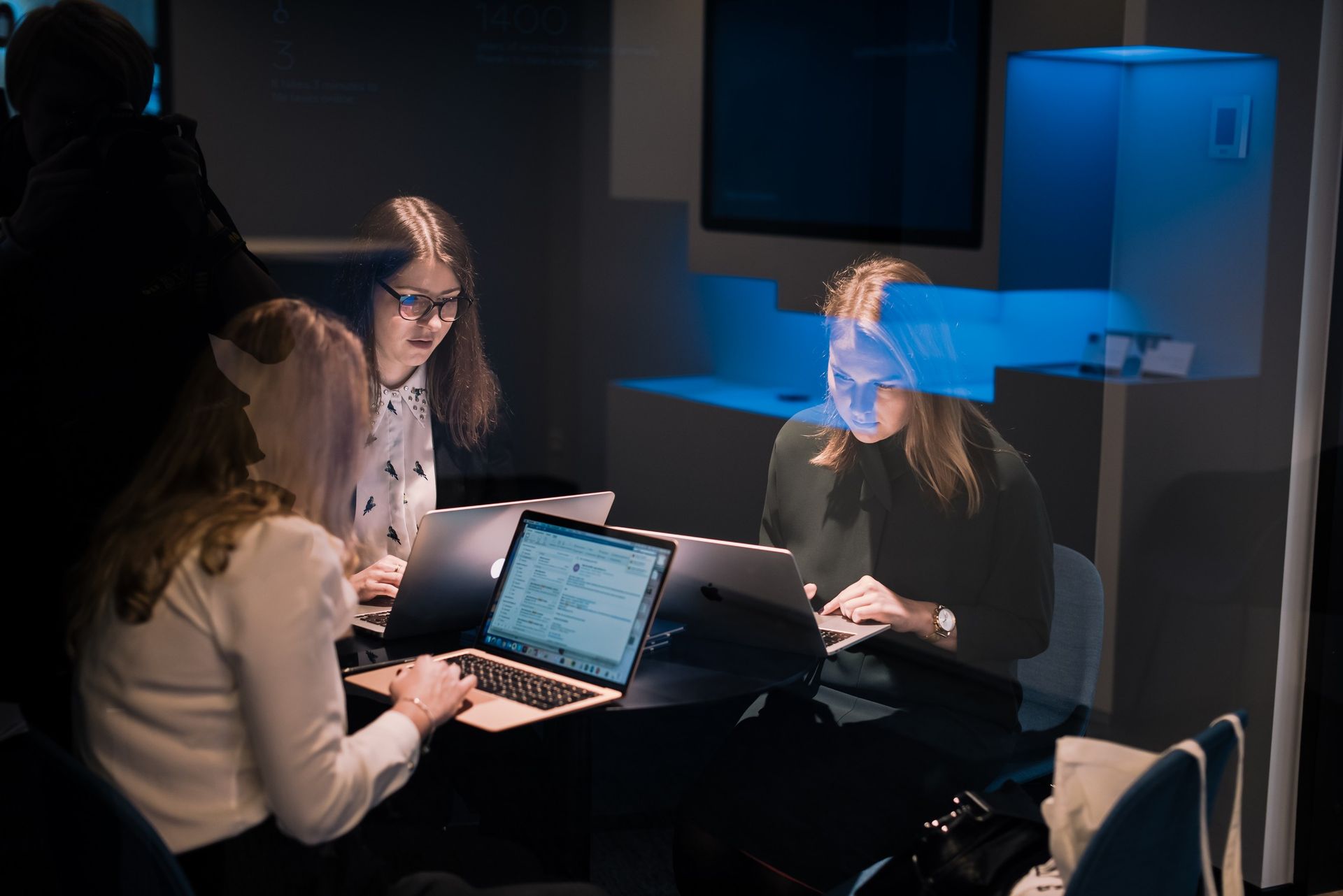 Three women working in Estonia on their laptops