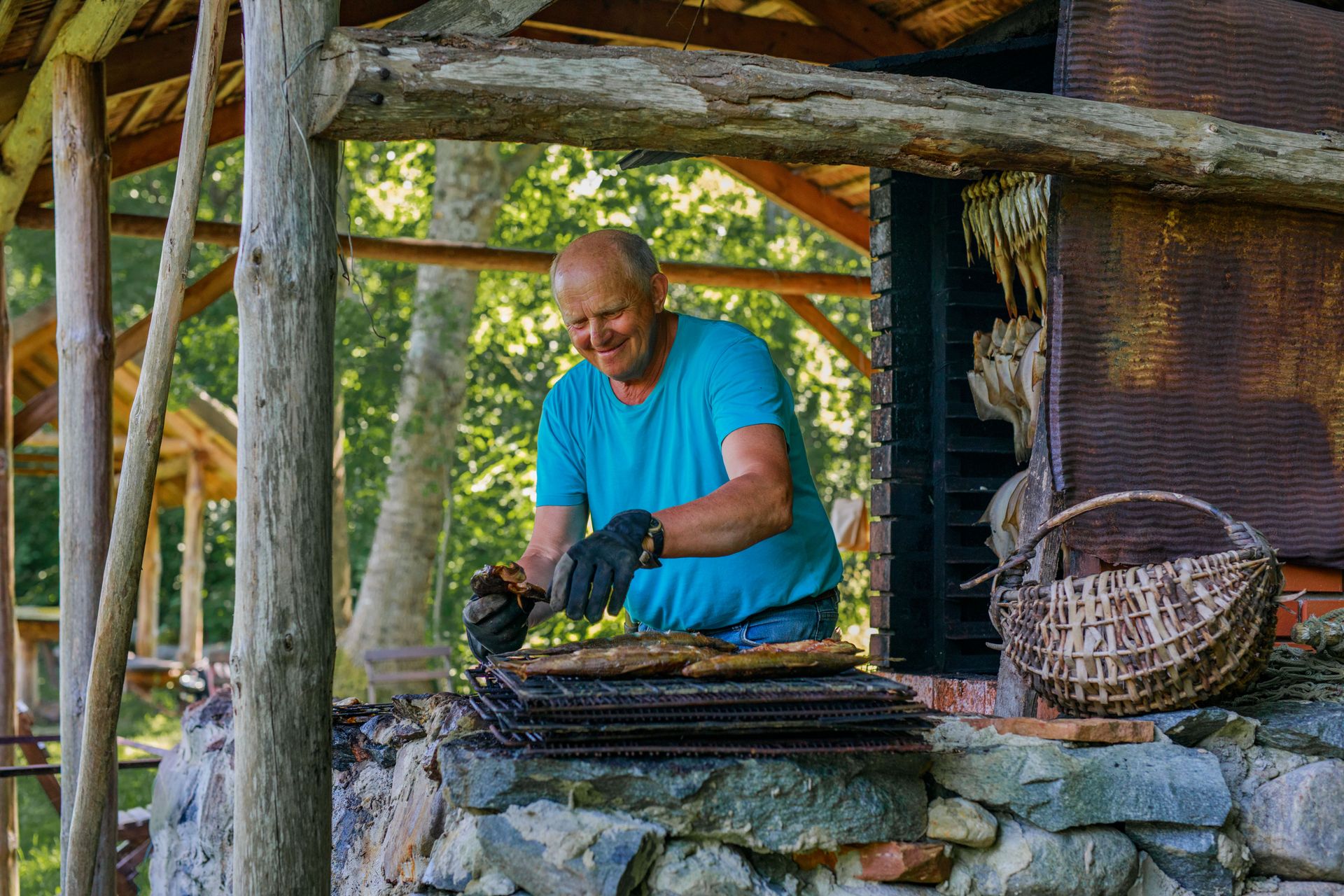 Ein Mann grillt Fisch auf Kihnu