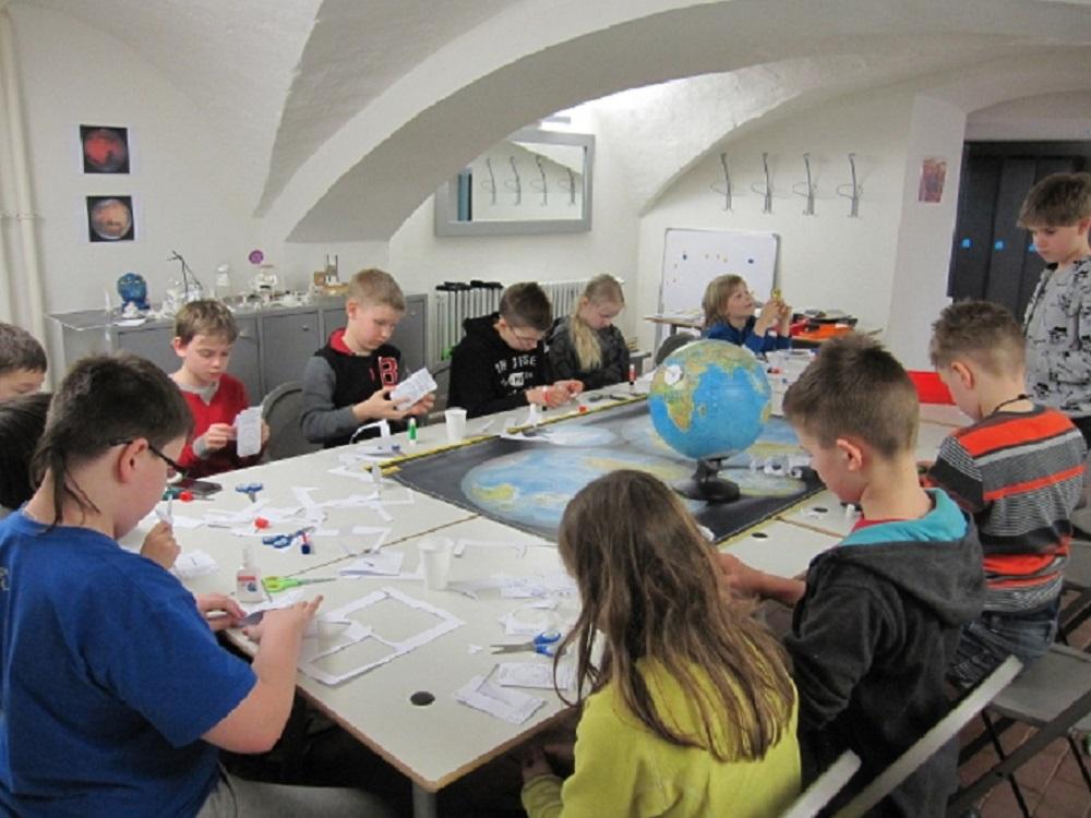 Tartu Old Observatory, educational programmes for children, children crafting around the table