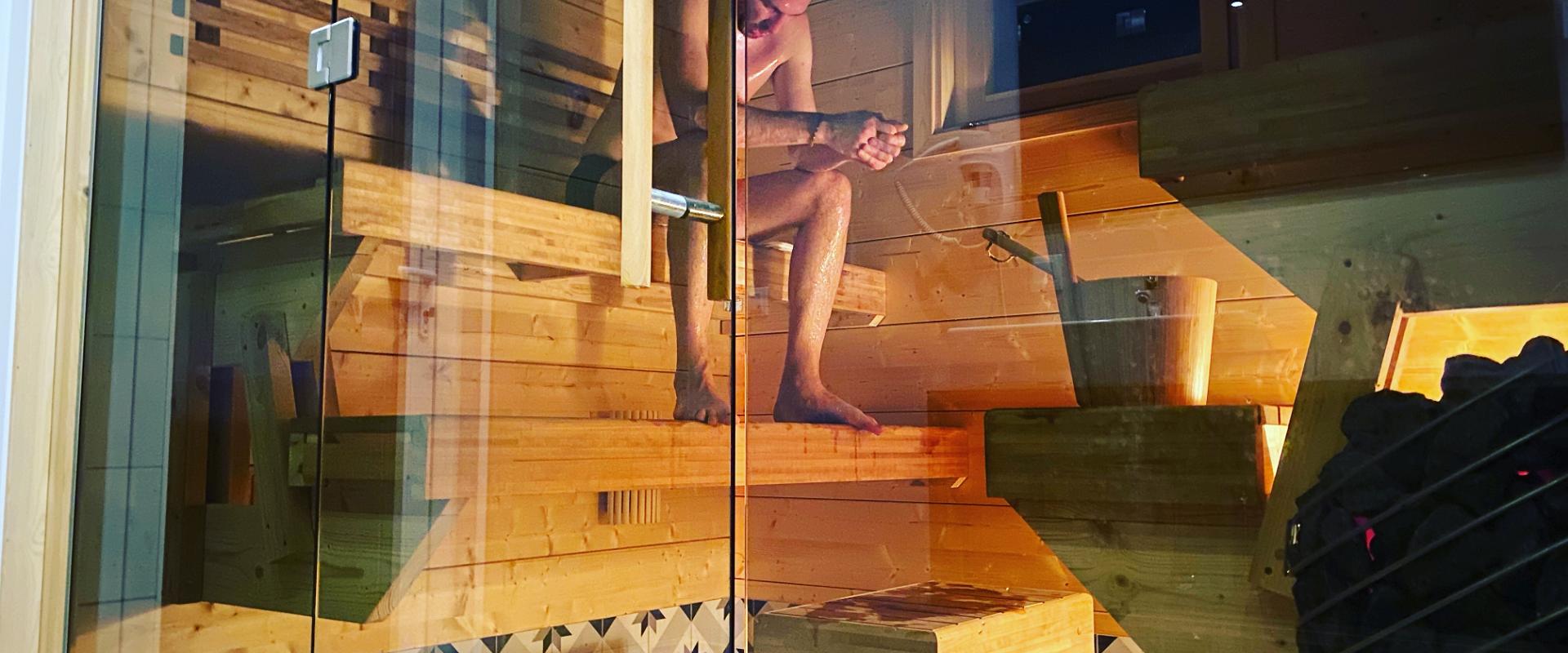 Karukella Holiday House, sauna and a person in the sauna