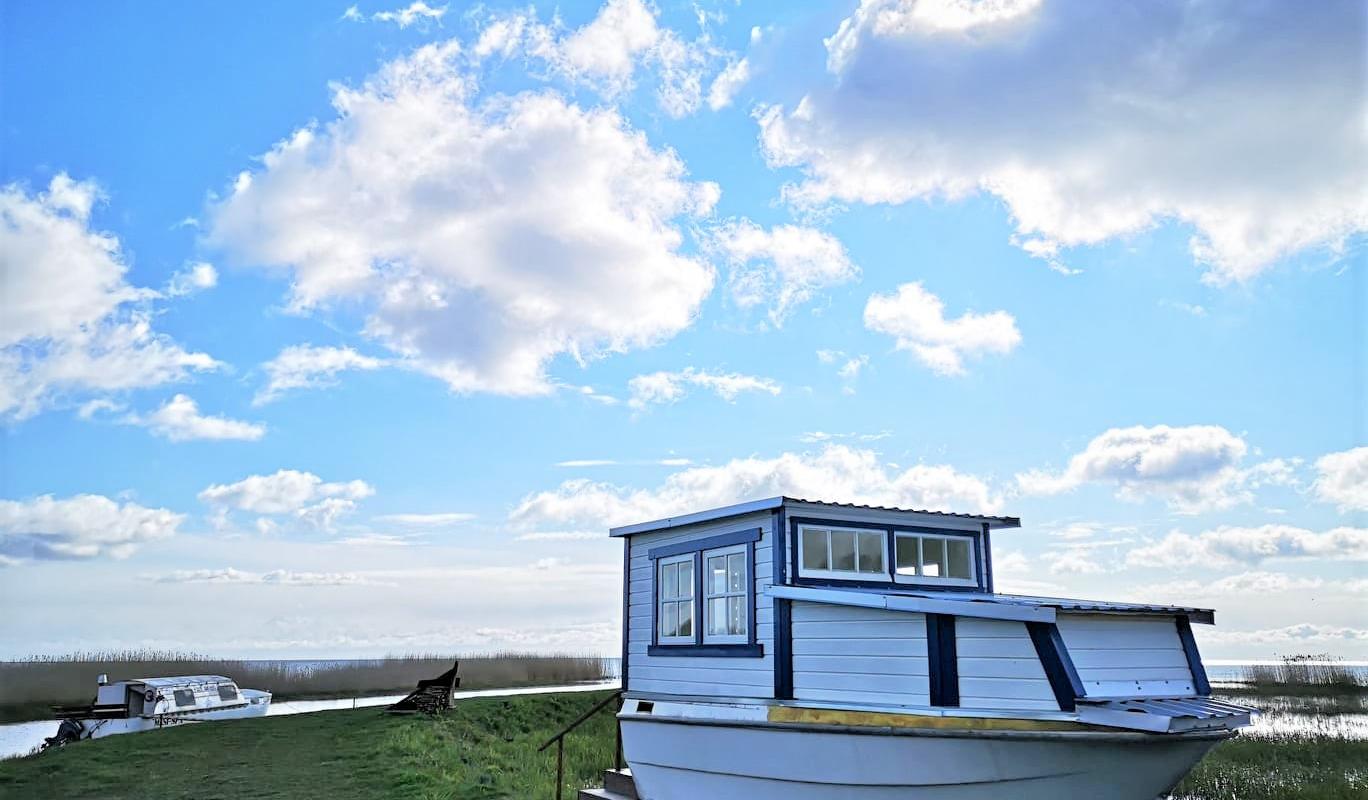 Sauna boat and white clouds in the light blue sky