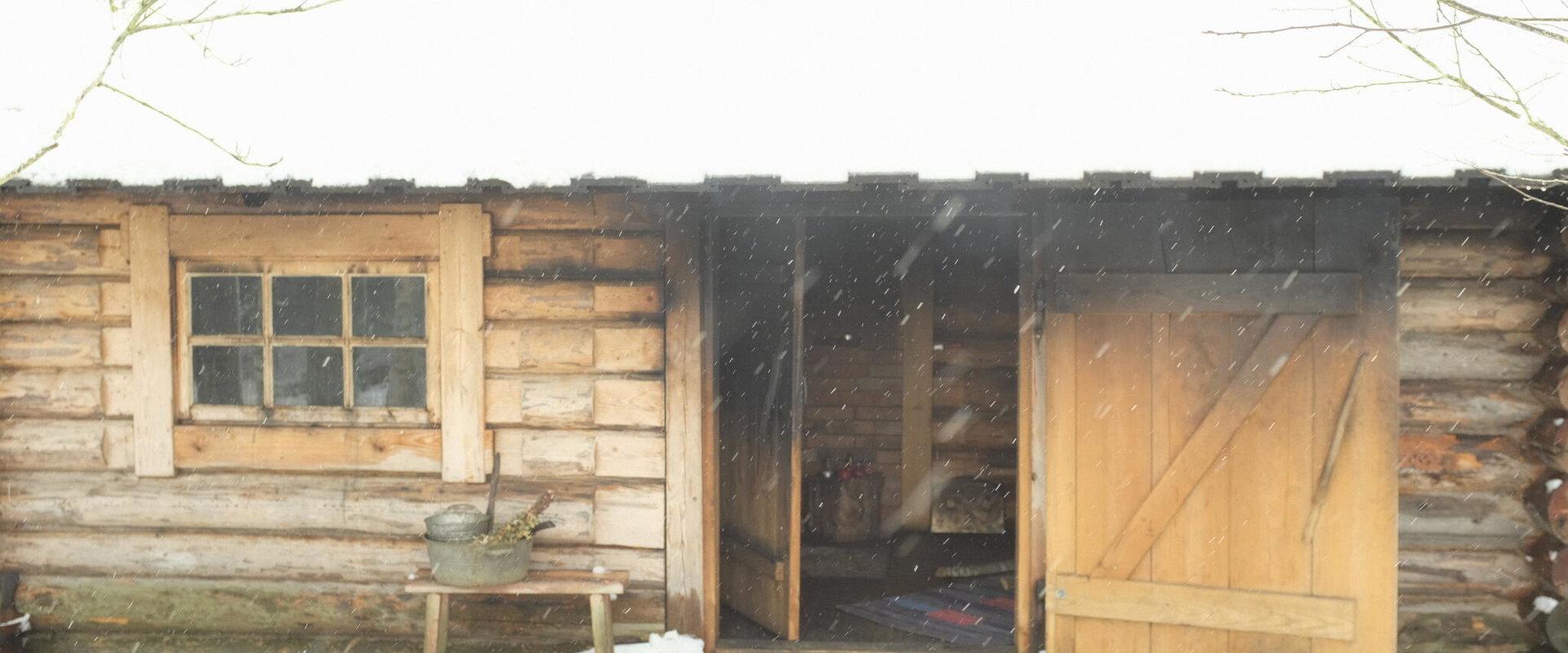 Traditional smoke sauna in winter