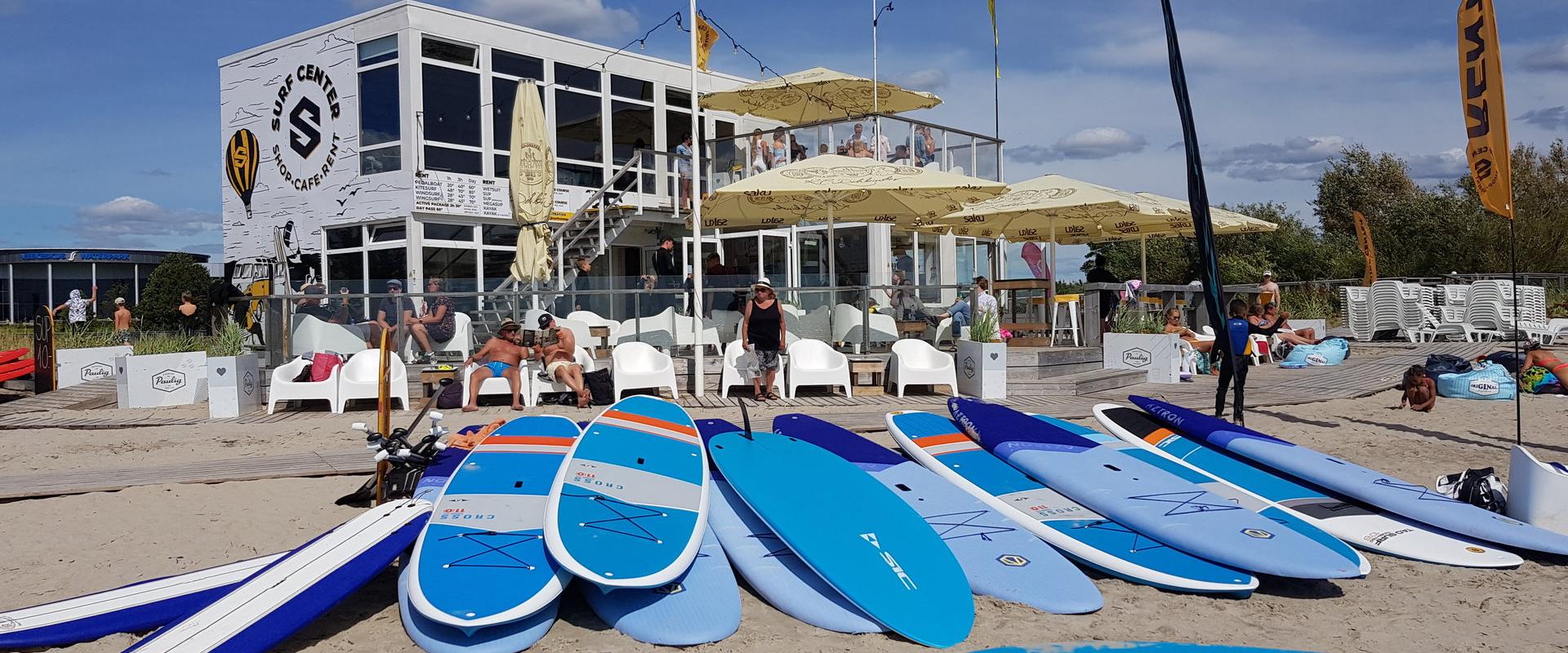 You will find Surf Centre at the beach by the yellow flags