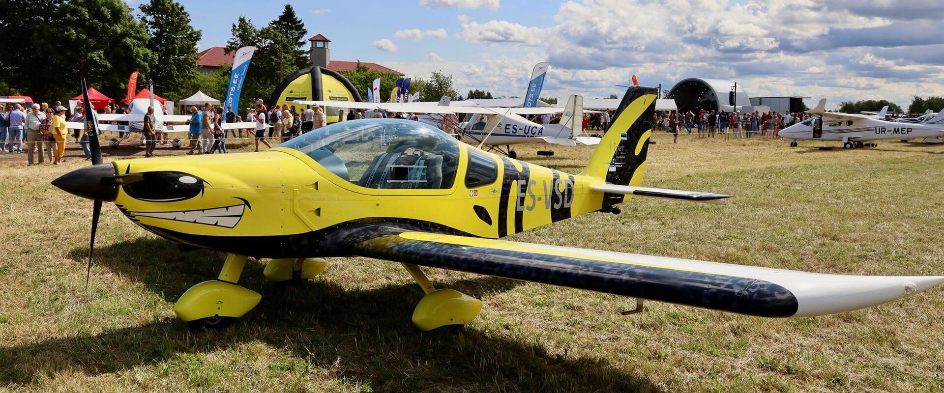 A small plane painted yellow and reminiscent of a sound cargo.