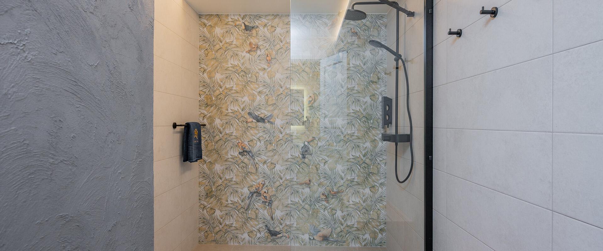 Kalda Villa kaasaegne duširuum troopilise mustriga seinal