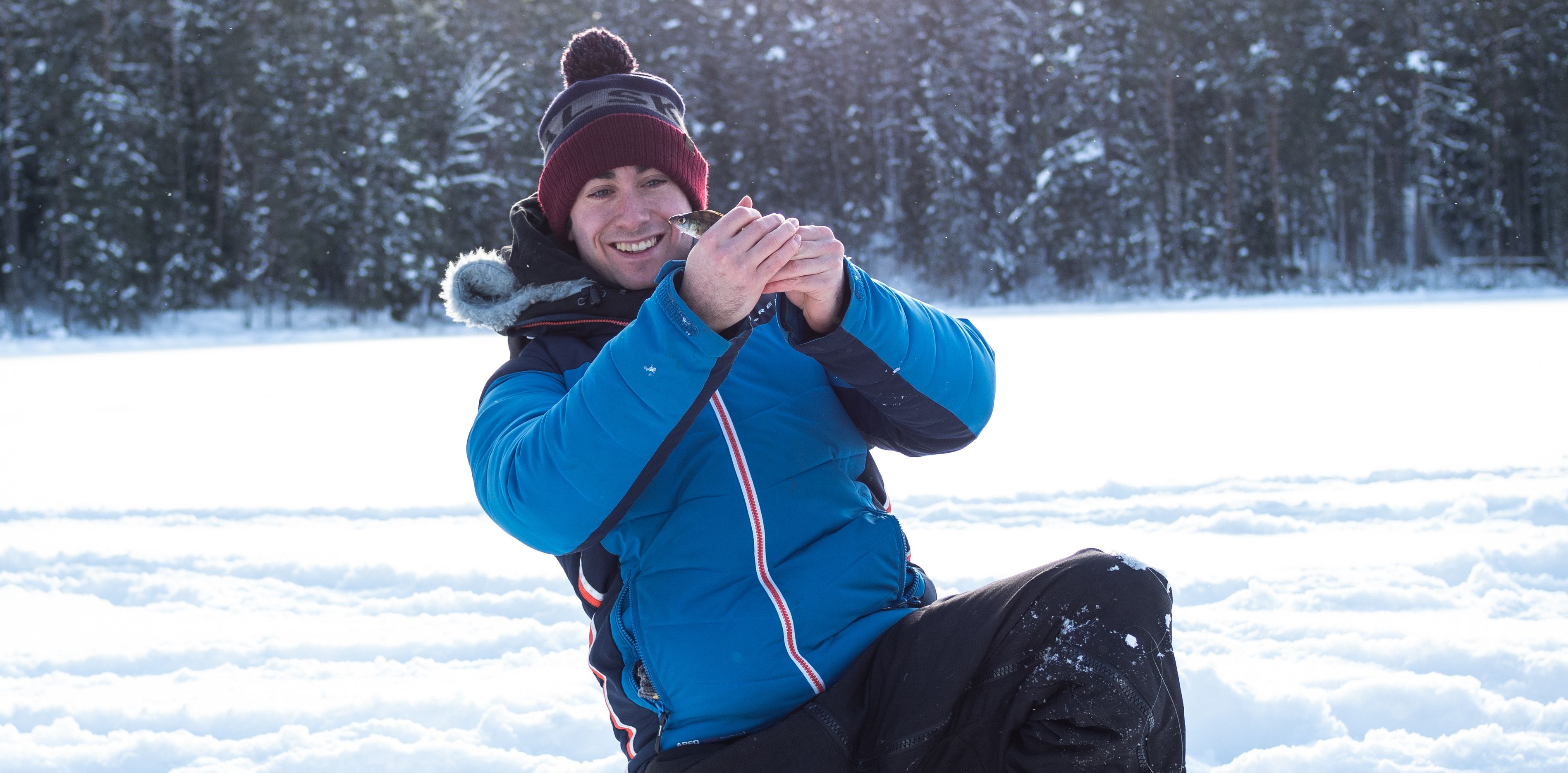 Catching a small fish from an ice hole