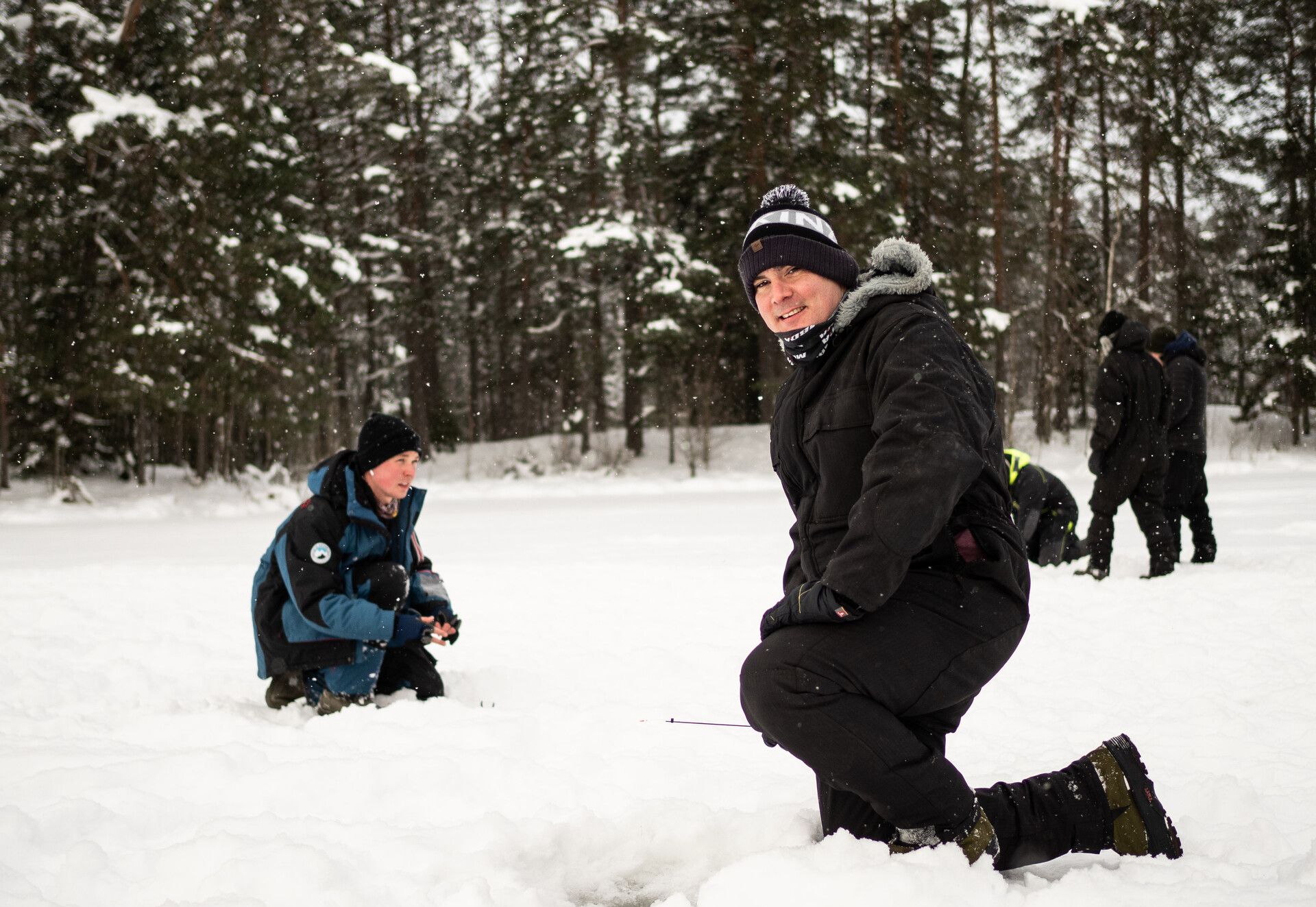 Ice fishing in the middle of snowy nature