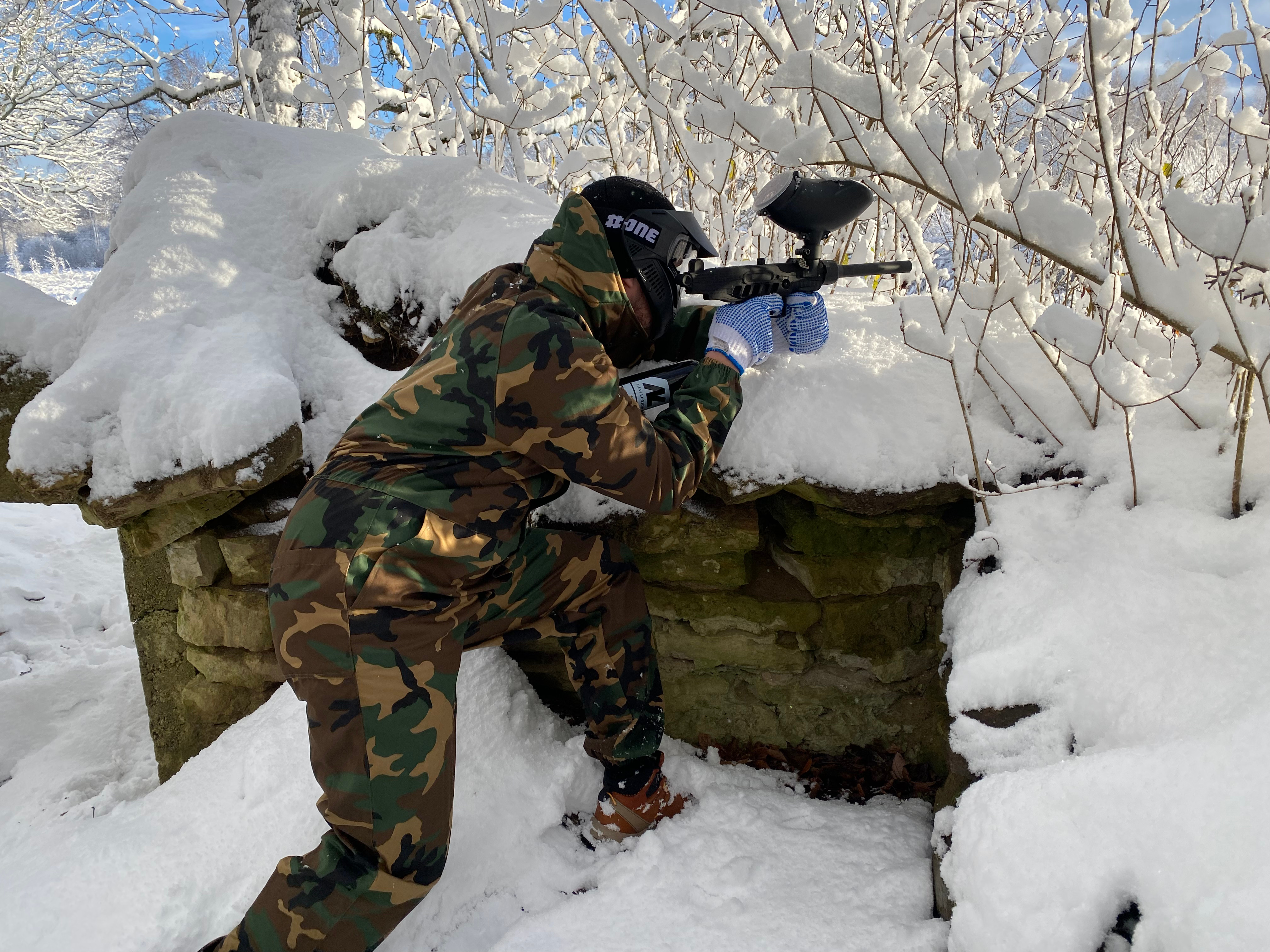 Braving the cold: Paintball player waiting 