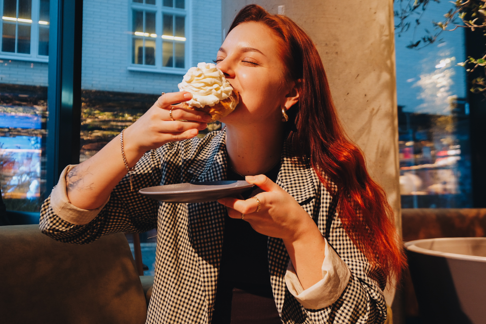 A girl enjoying Shrovetide cream buns