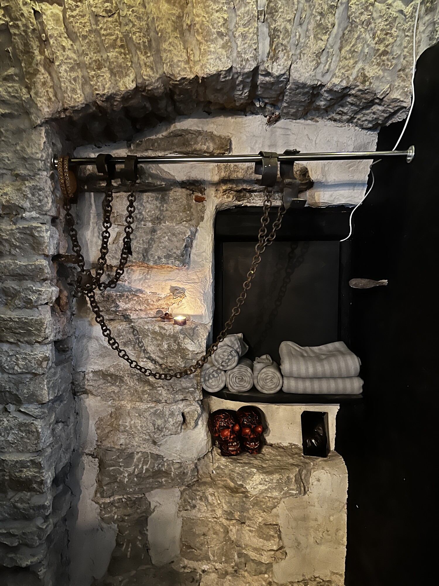Metal meets stone, black paint and candlelight lit rooms