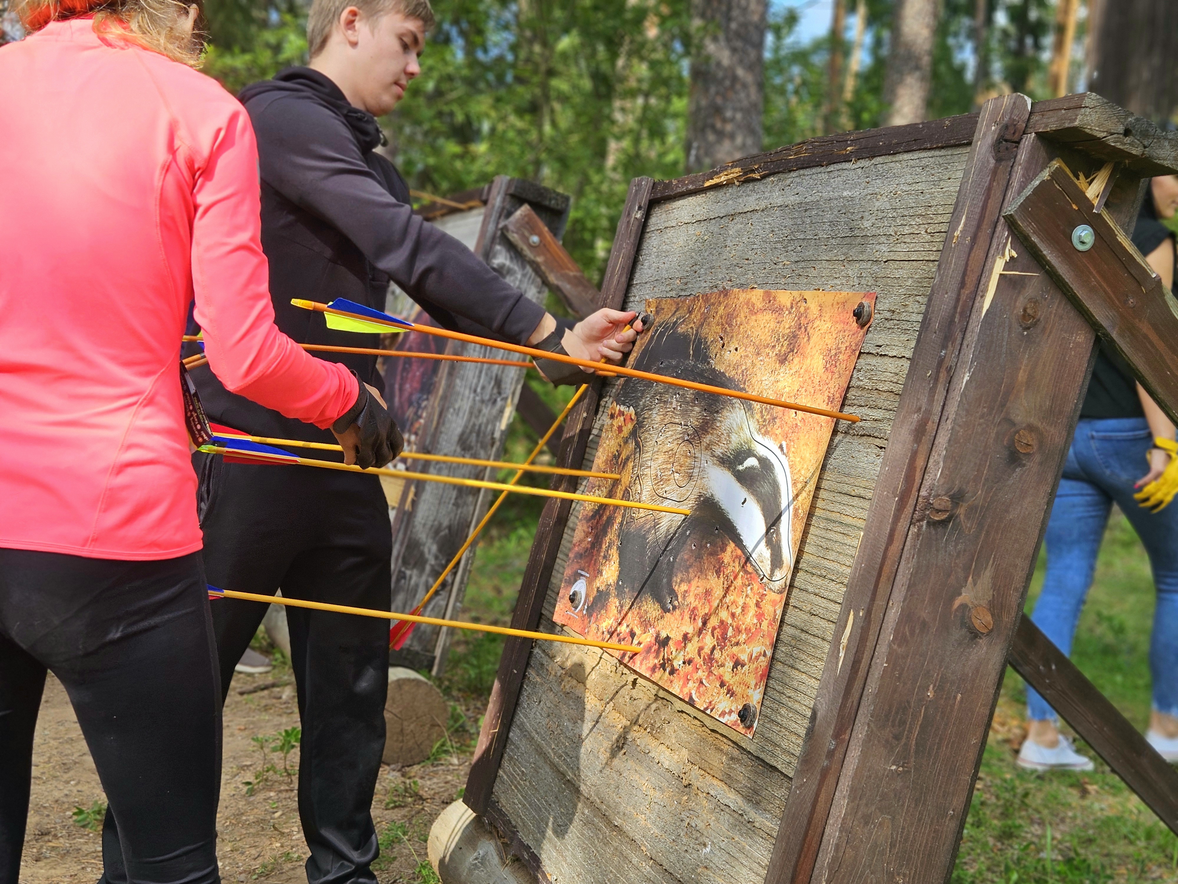 Removing arrows from an archery target.