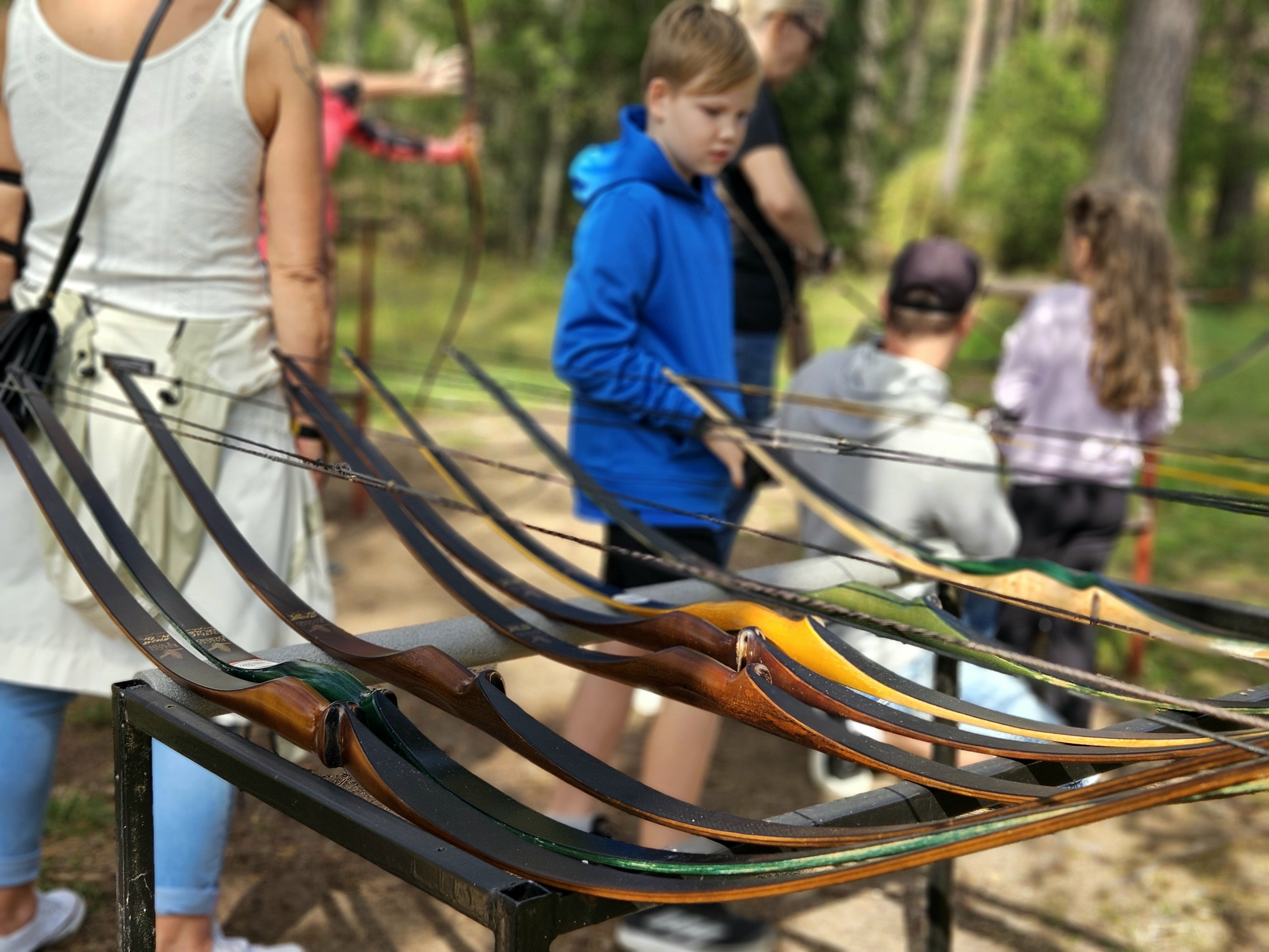 Bows on a rack at an archery event.