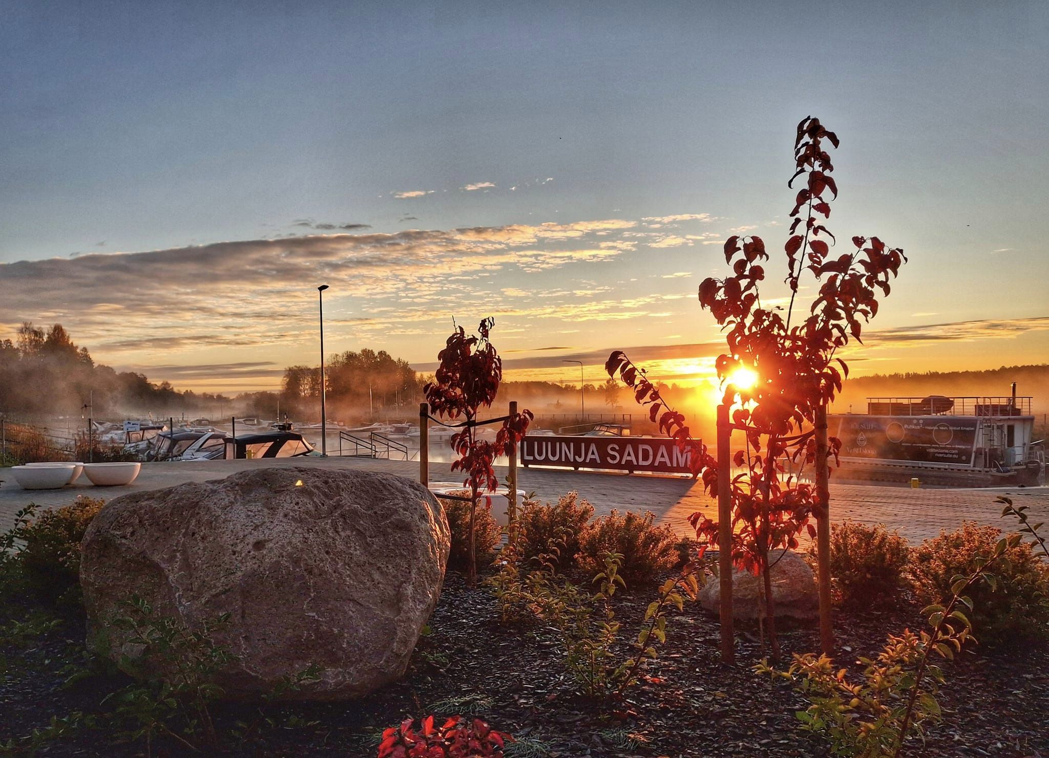 Sunrise at Luunja Harbour with mist and boats