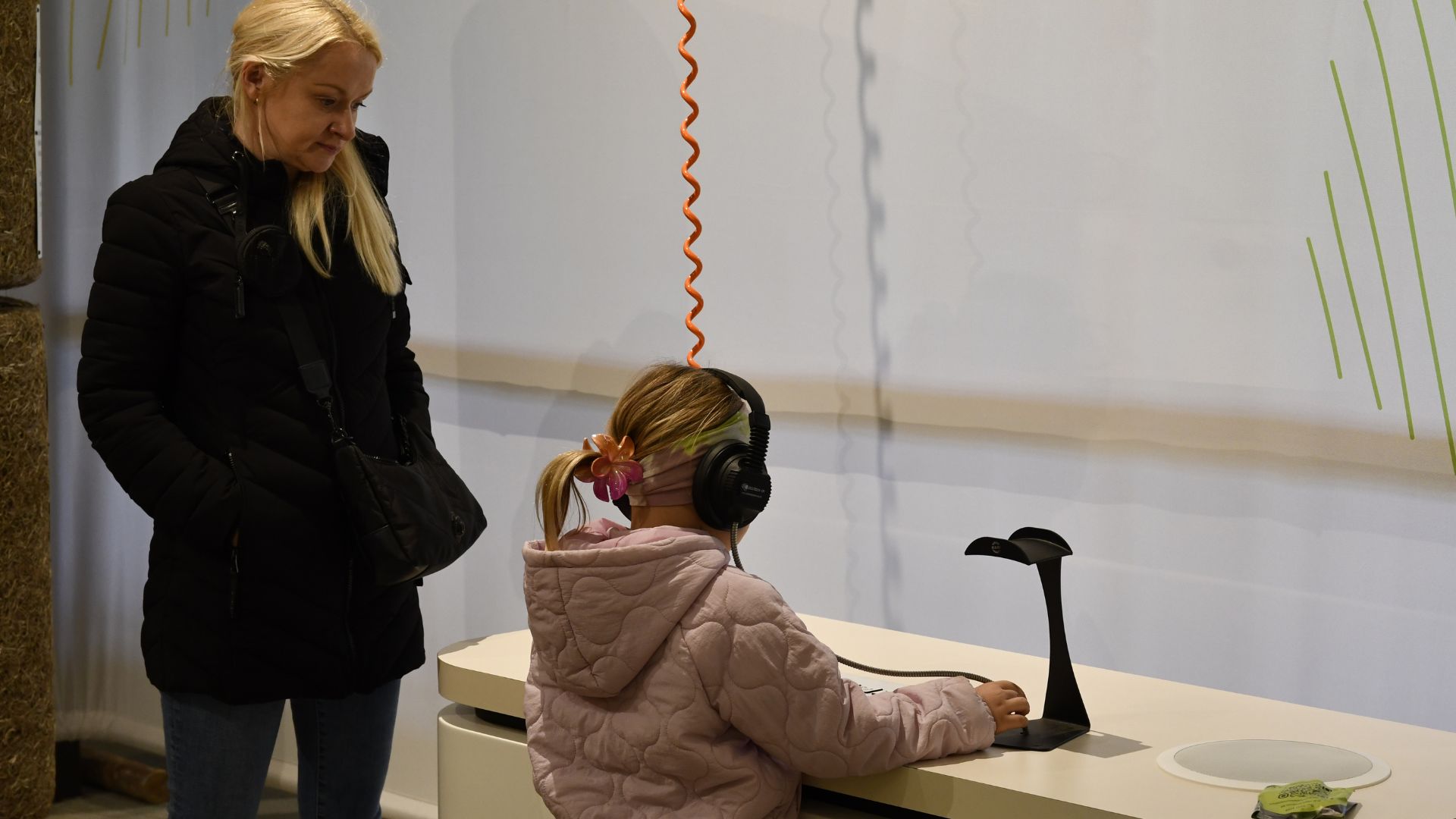 A visitor listens to the sounds of farm life with headphones on the Farm Symphony music machine 