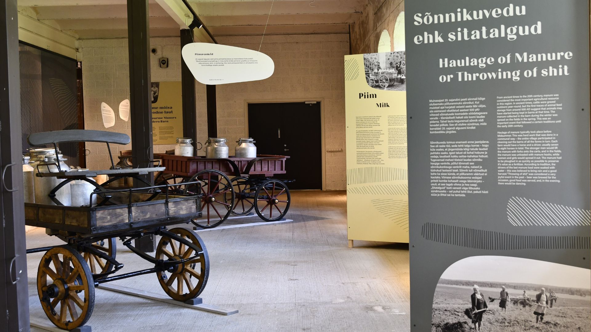 Historic manure and milk carts and information boards that introduce the history of farm work