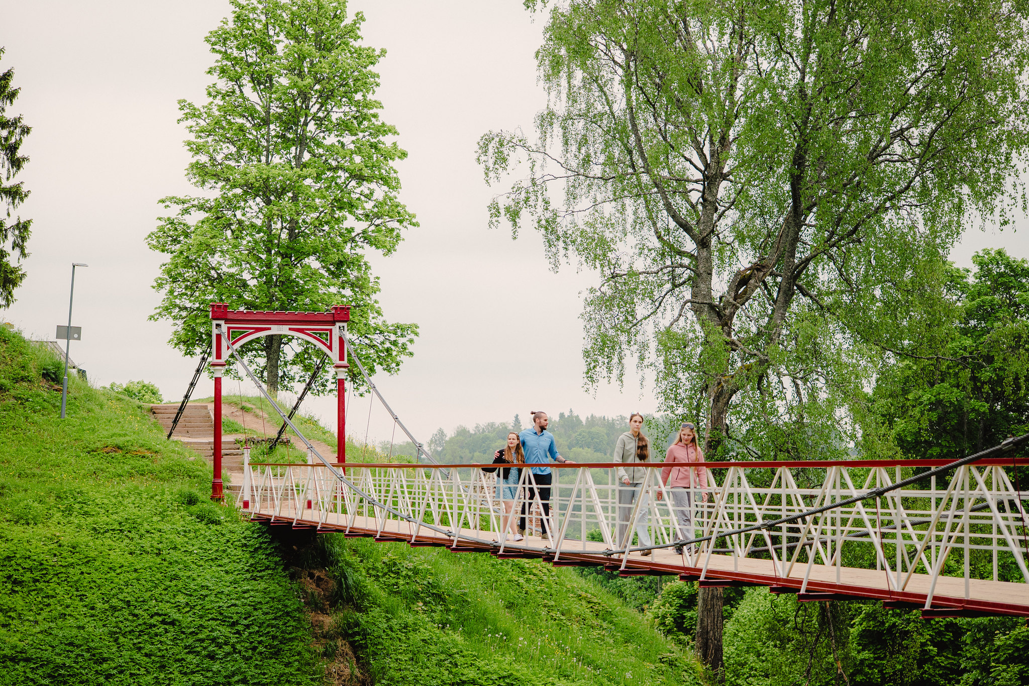 A family walking on the Viljandi suspension bridge