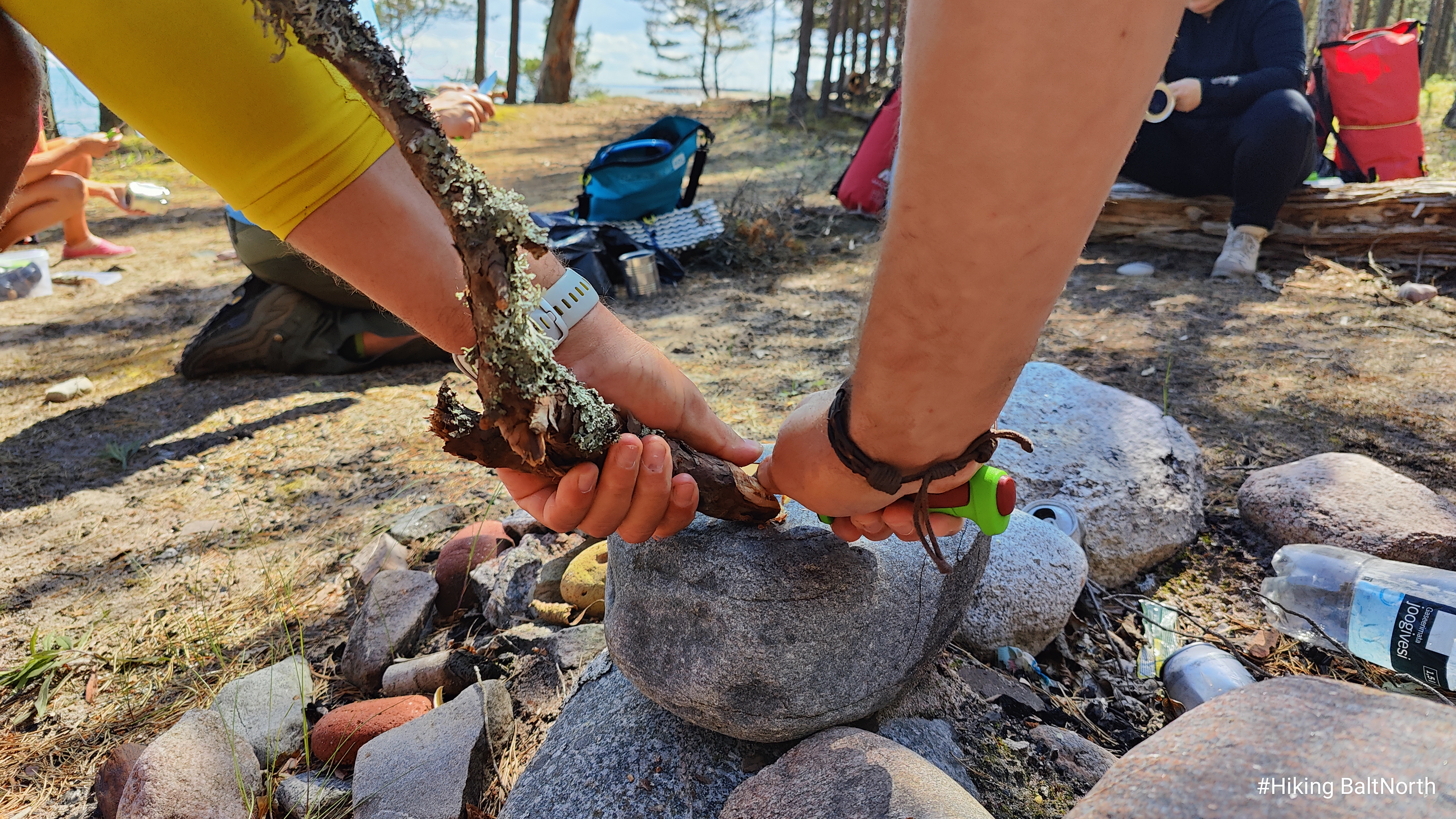 Lighting a fire with a stone in survival training