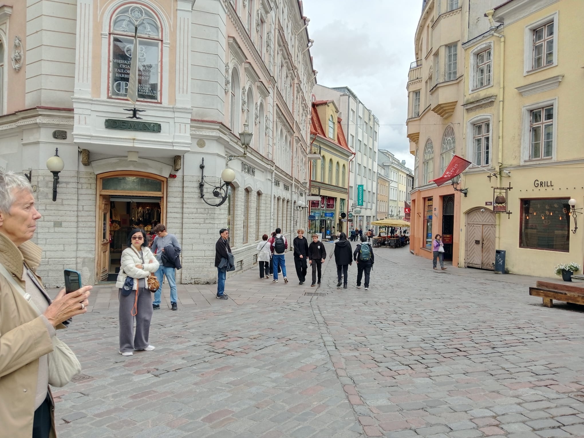 People are walking on along a street in Tallinn Old Town