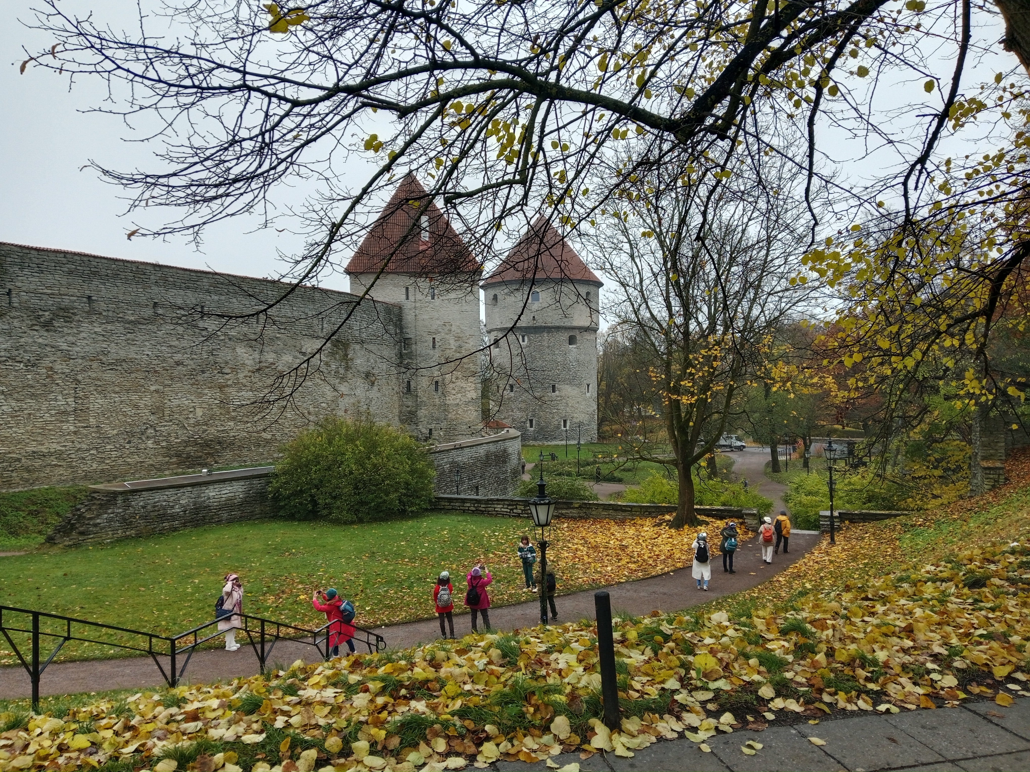 People are visiting and taking pictures at Tallinn Old Town City Wall