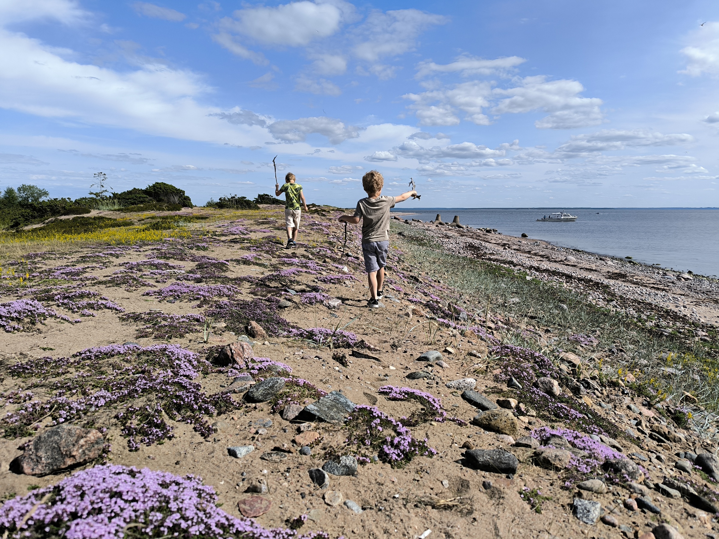 Coastal plants and children on the shores of Aksi Island