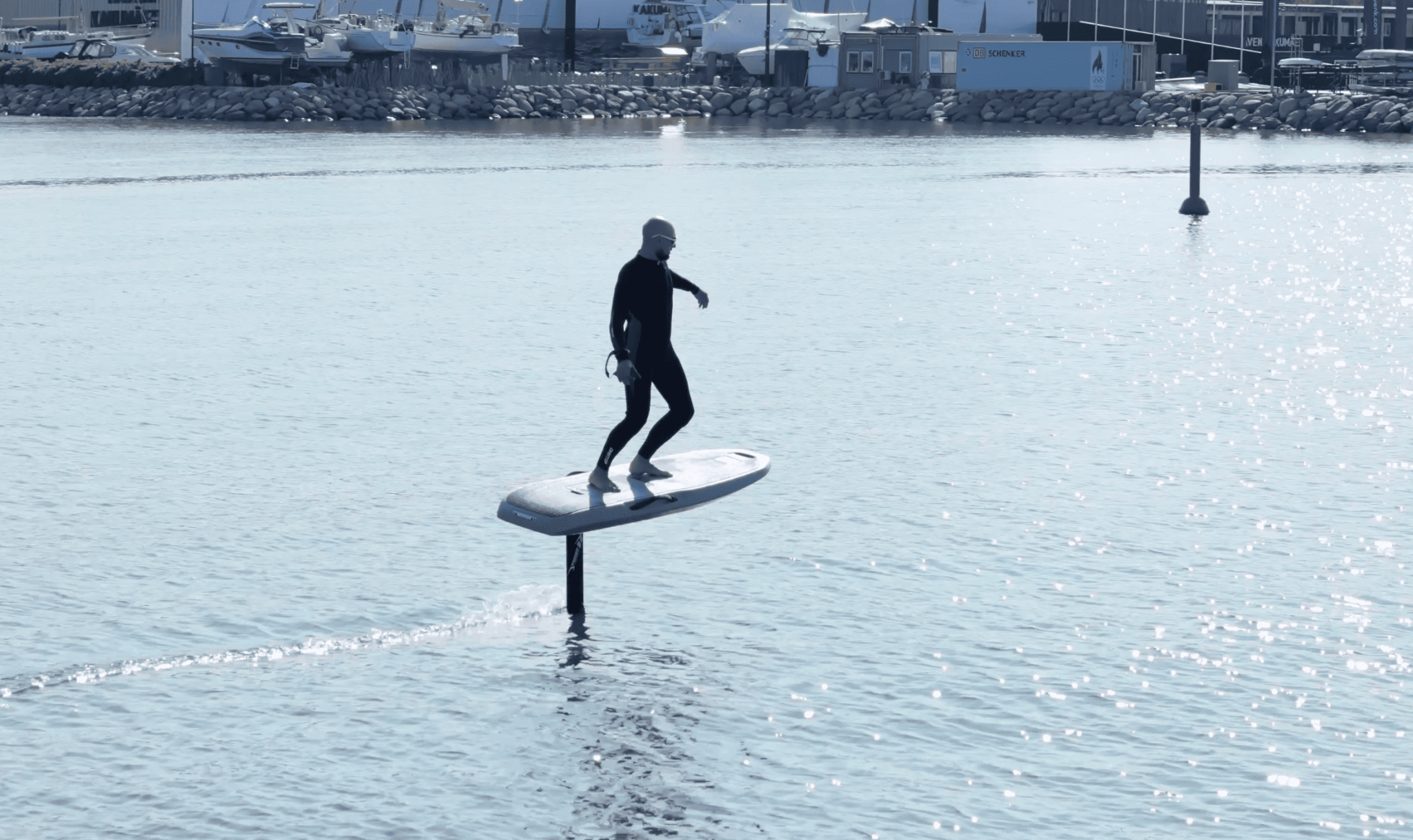 Riding an eFoil electric surfboard at sea