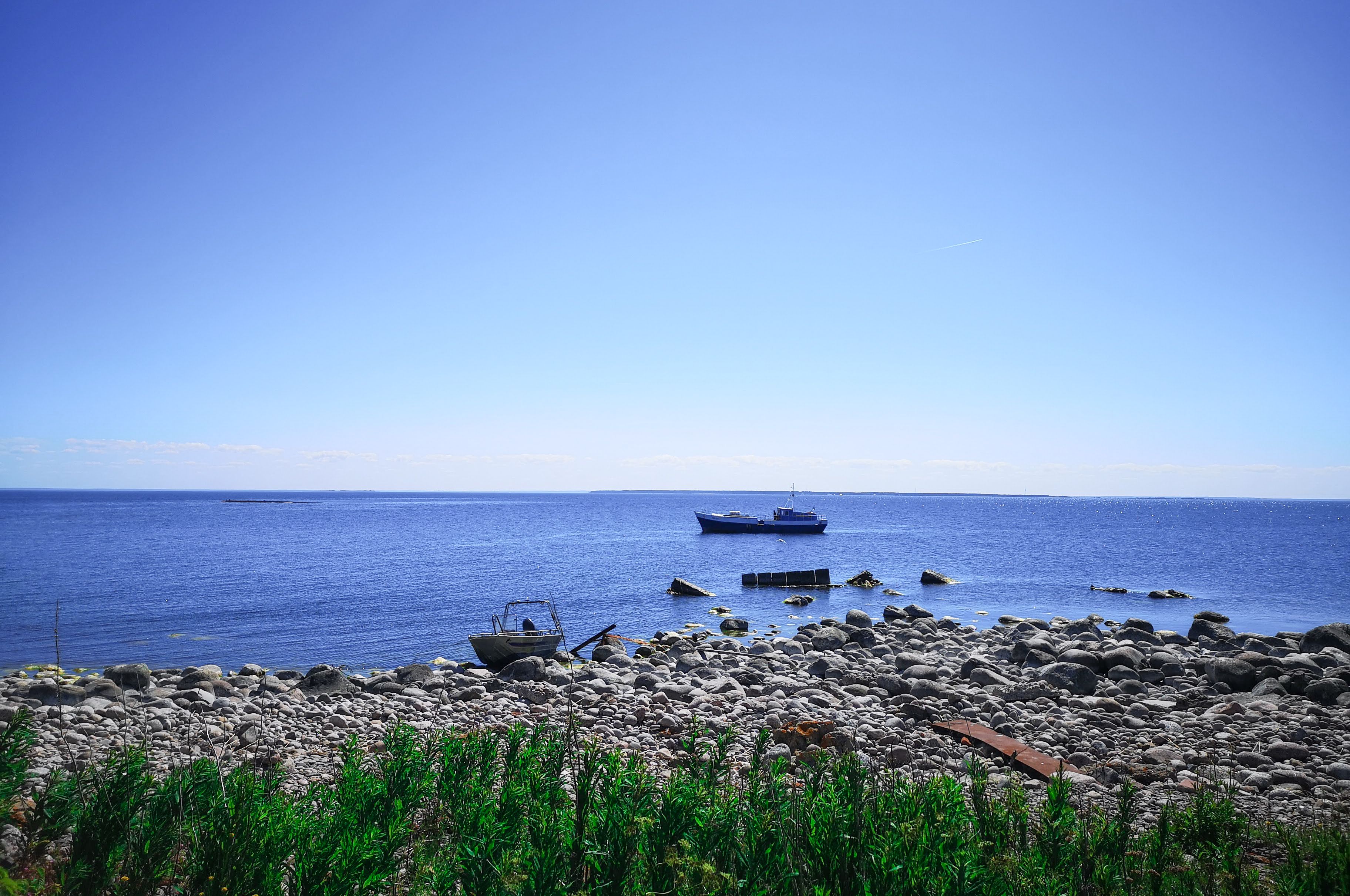 Rocky beaches and anchored ships