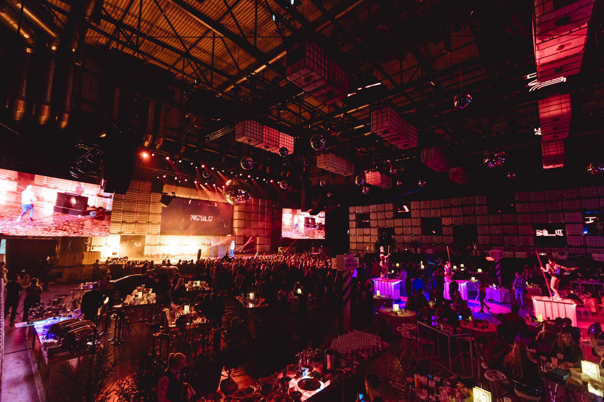 Large event space with stage and show for corporate event