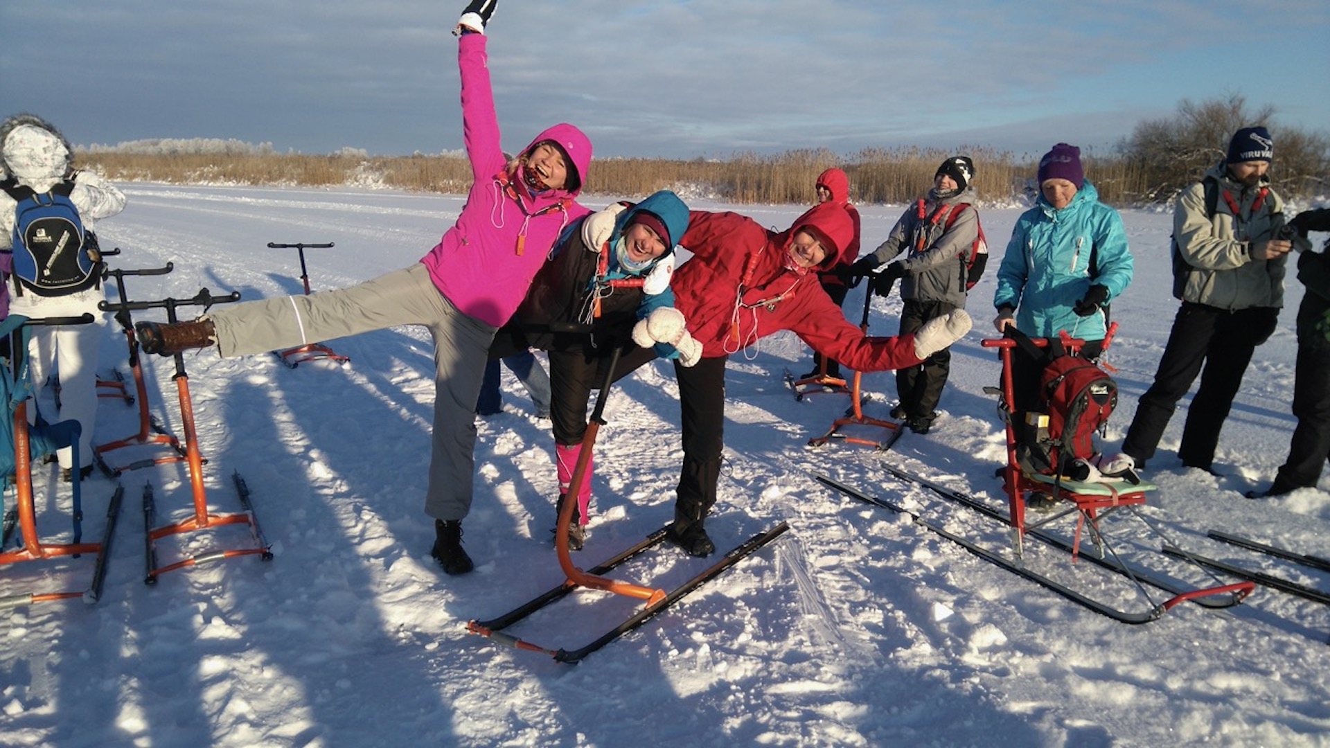 Three hikers make a swallow on the sunny ice.