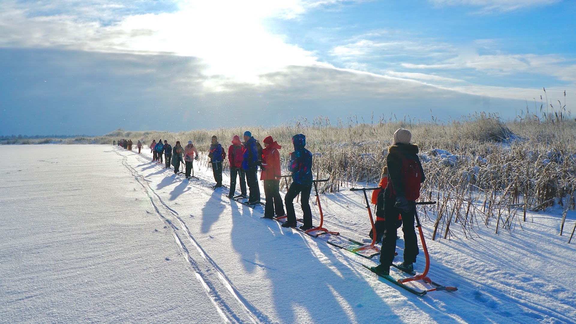 A group of travelers on the ice in sunny Võhandu river.