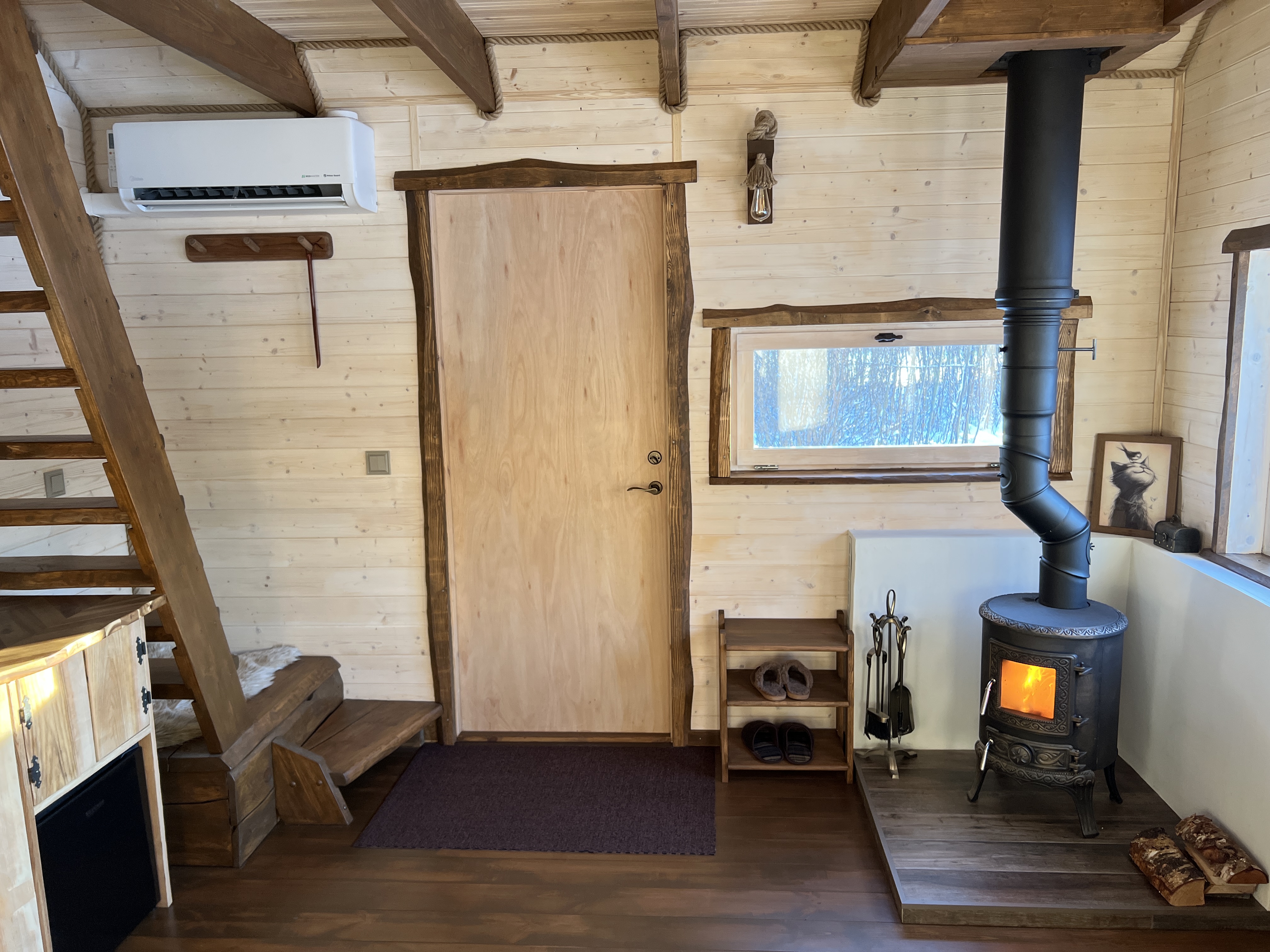 Viesu nama "Hobu House" interjers - kamīns un kāpnes uz guļamvietām
