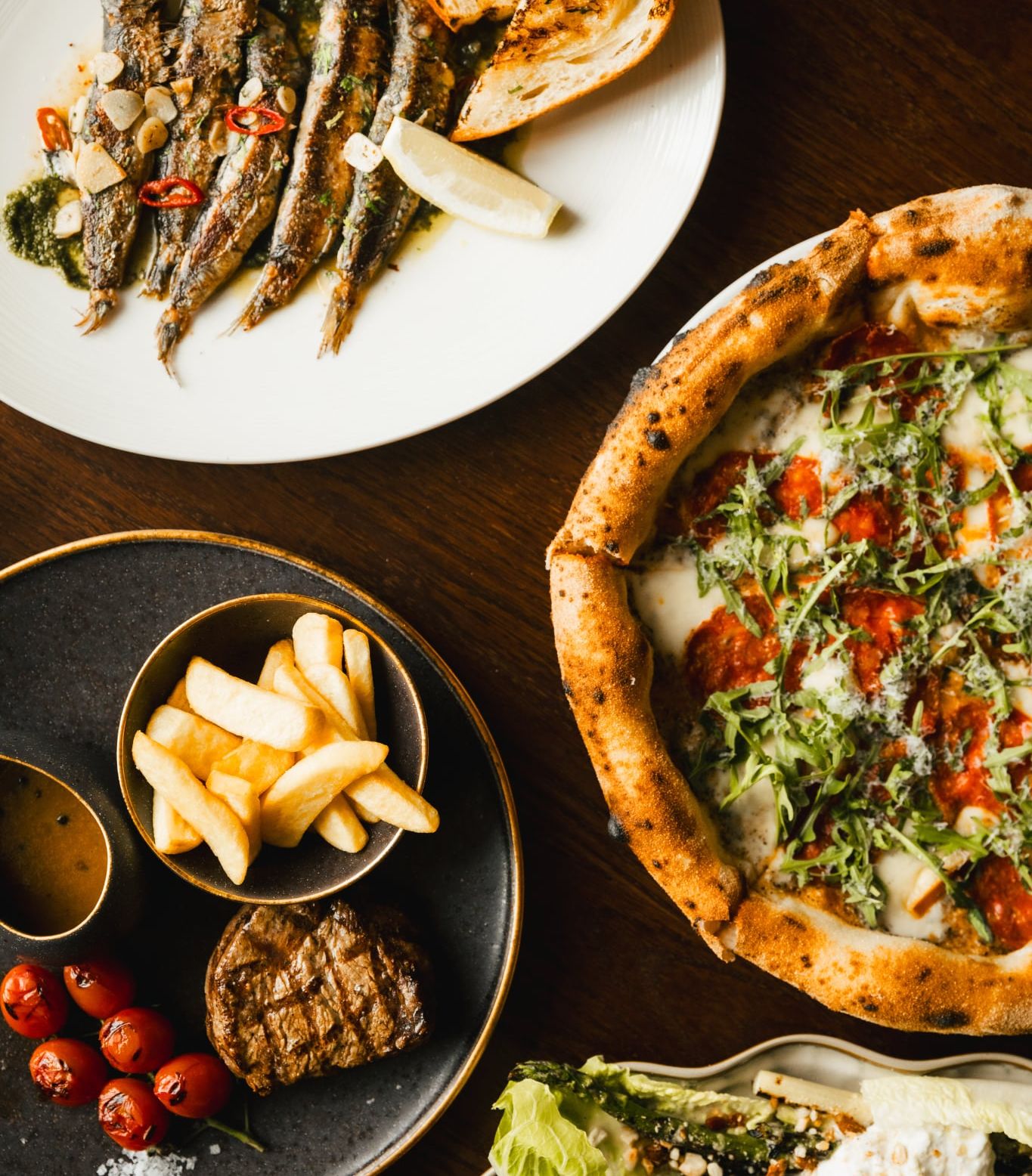Selection of Italian flavors at Como Restaurant: sardines and pizza