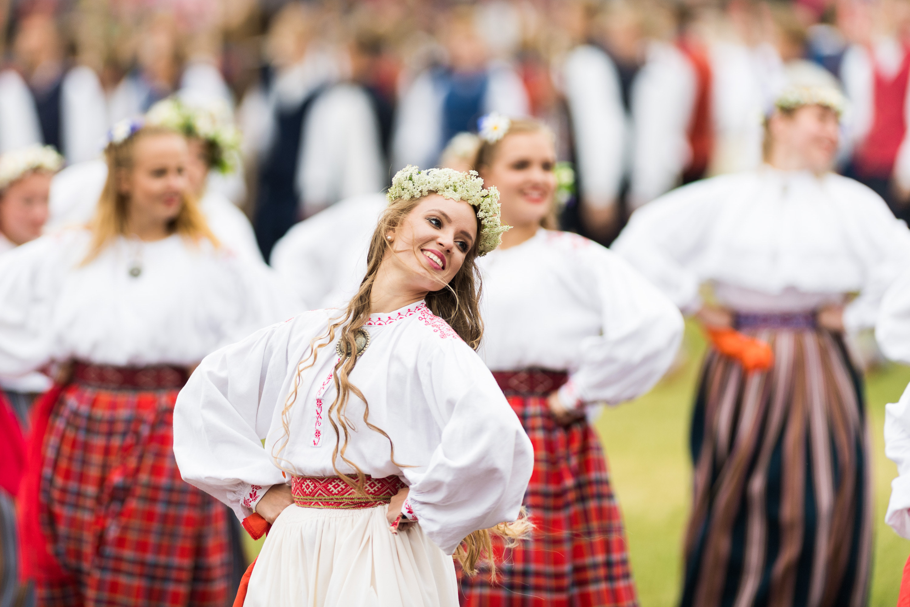 A folk dancer with a flower wreath at the dance festival in Tallinn